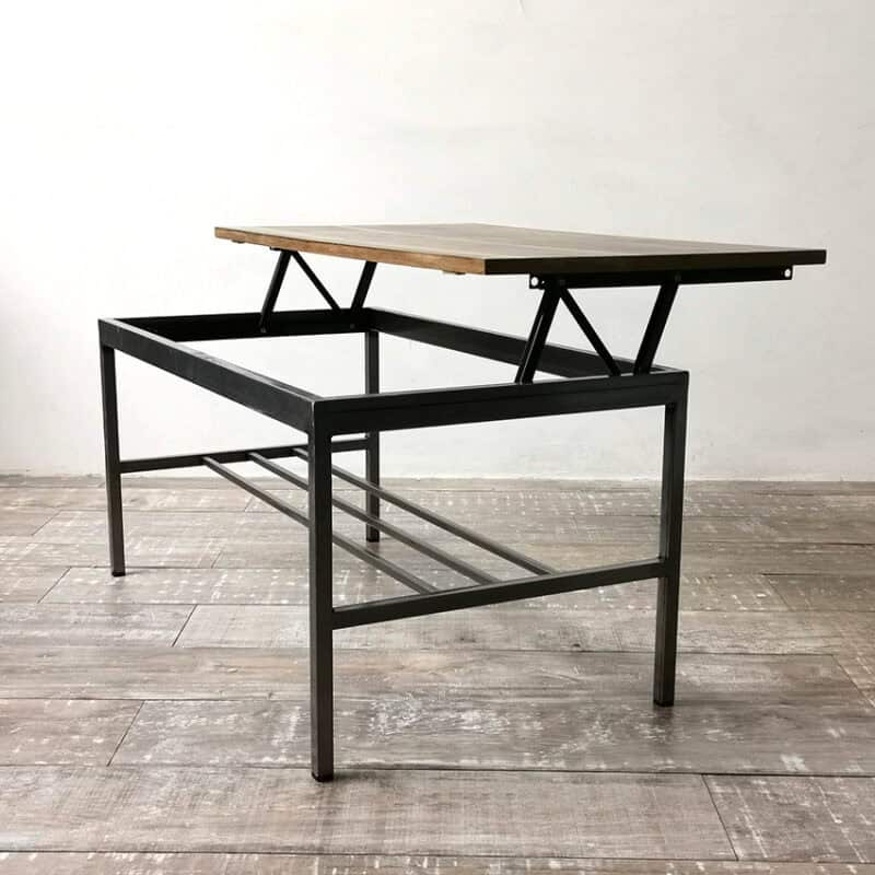 Mesa elevable con estructura negra y tapa de madera natural.